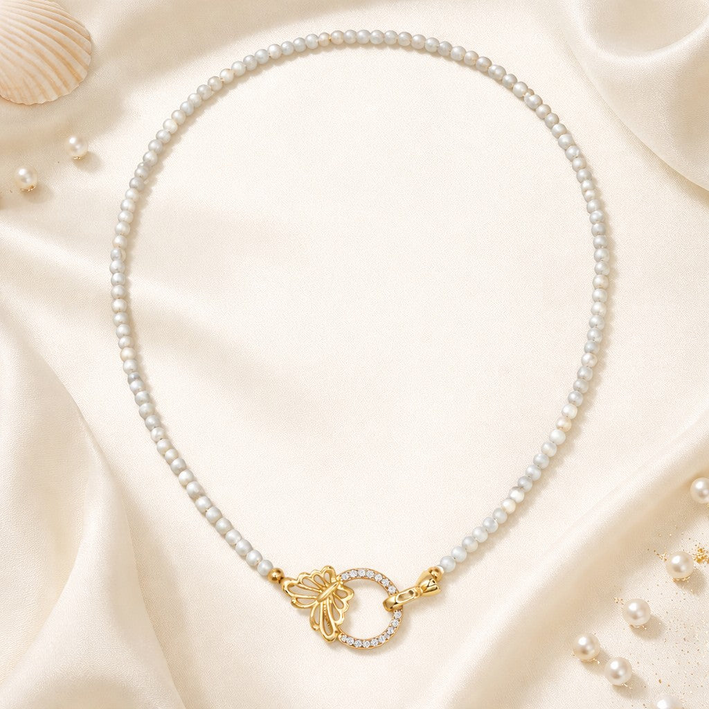 Mellow Monkey 18K gold plated choker with mother of pearl beads and a butterfly clasp with cubic zirconia.