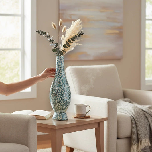 Mellow Monkey 26-inch tall bottleneck vase with iridescent blue capiz shell mosaic tiles on a wooden side table