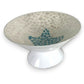 Mellow Monkey 14-inch capiz shell pedestal bowl featuring a shimmering white finish and a blue mosaic starfish center.