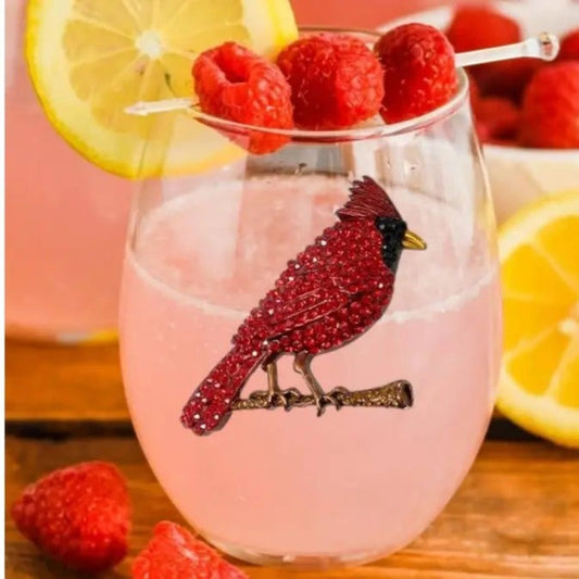 Mellow Monkey stemless wine glass featuring a red jeweled cardinal bird design, filled with a pink cocktail.