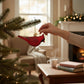 Mellow Monkey Northern Cardinal glass ornament, 4-1/4-in, red with glitter detail, hanging on a Christmas tree.