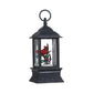 Mellow Monkey lighted holiday water lantern featuring a red cardinal inside a black plastic snow globe frame