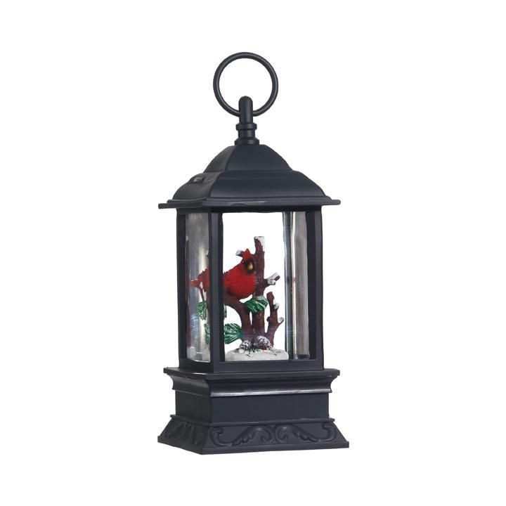 Mellow Monkey lighted holiday water lantern featuring a red cardinal inside a black plastic snow globe frame