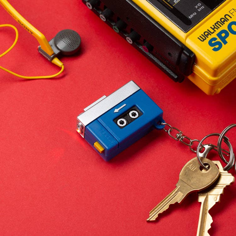 Mellow Monkey blue and silver cassette tape player keychain with LED light and sound effect on a red background