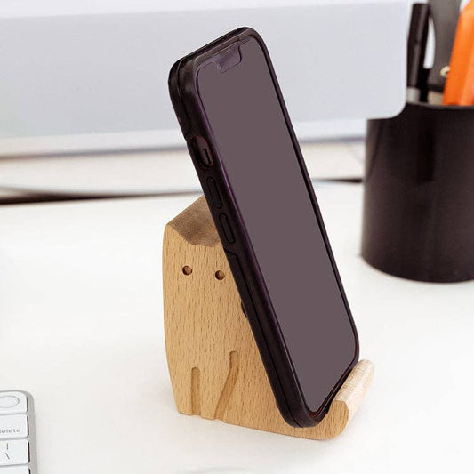 Mellow Monkey cat-shaped beechwood phone stand holding a smartphone on a desk