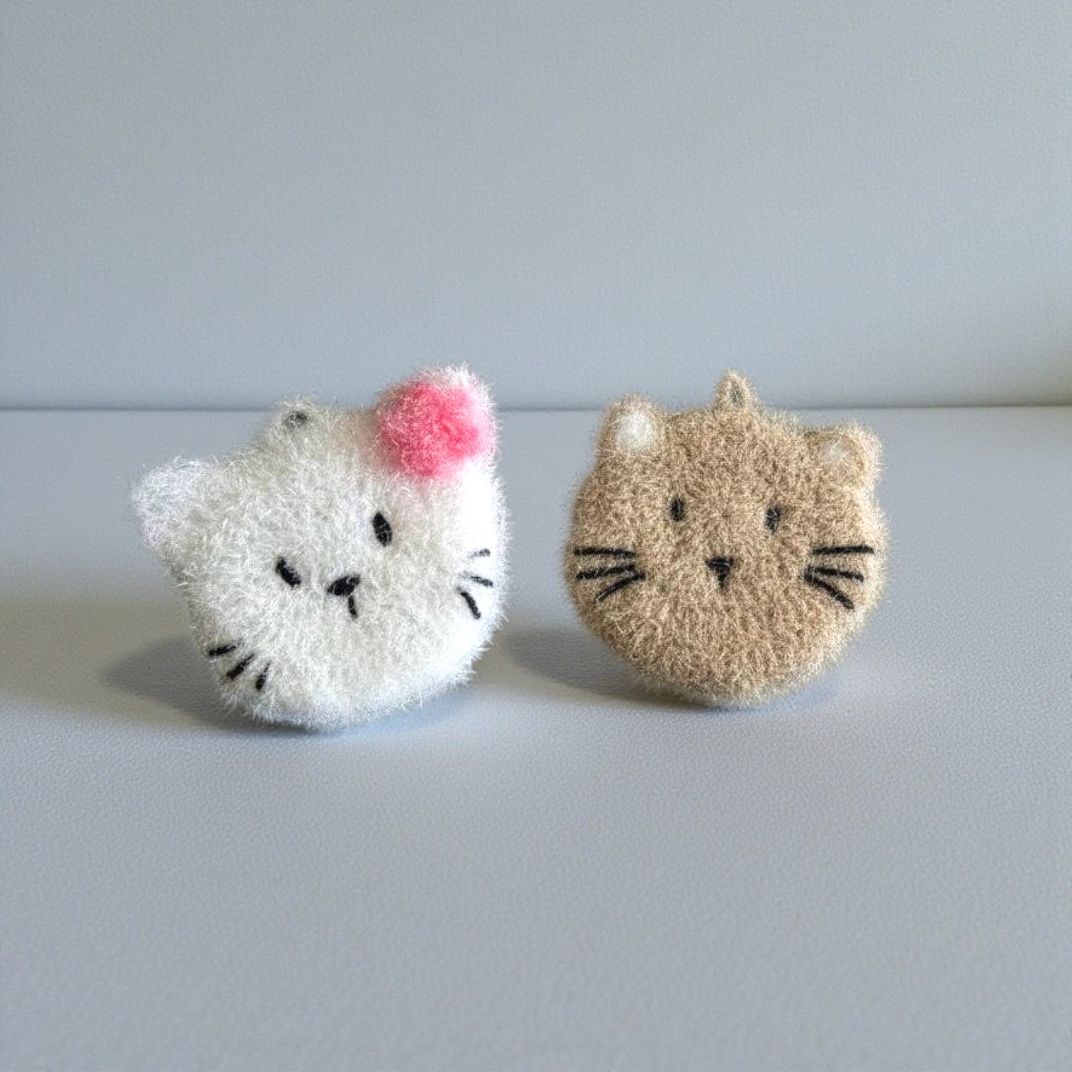 Mellow Monkey Pearl & Moki Scrubby Set: white cat with pink bow and taupe cat dish scrubbers. Dual-sided for versatile cleaning.