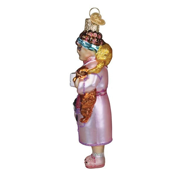Mellow Monkey Cat Lady blown glass ornament with two cats, wearing a pink robe and slippers.