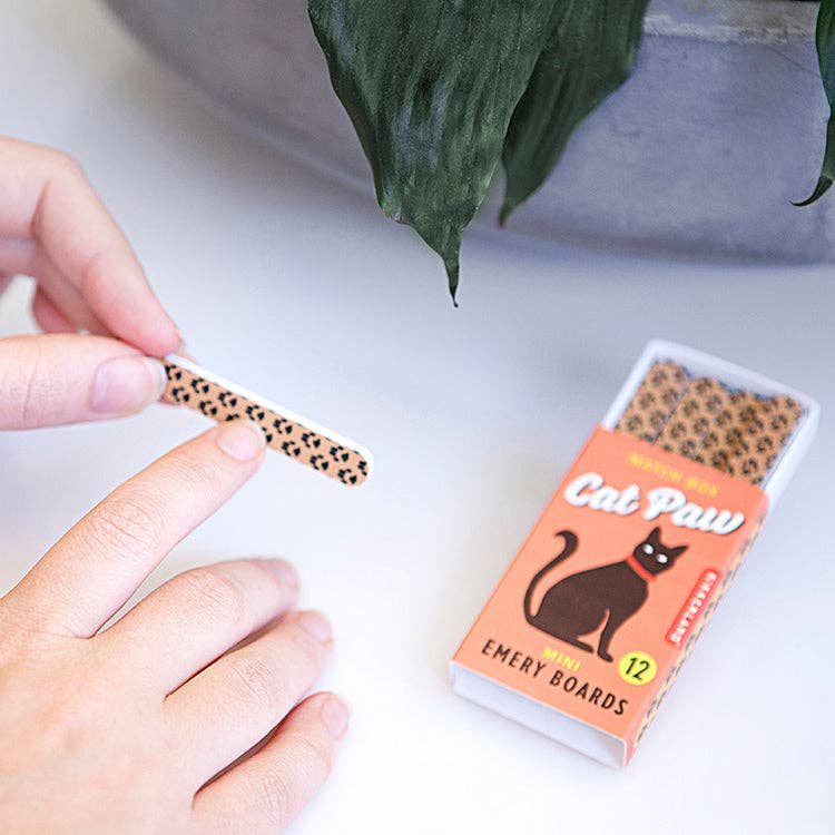 Mellow Monkey cat paw patterned emery boards in a quirky matchbox with a hand holding one nail file