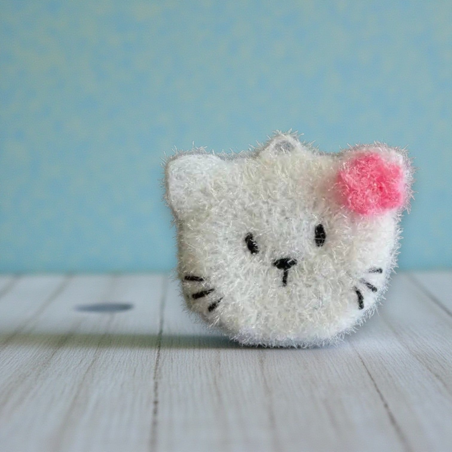 Mellow Monkey white cat scrubby sponge with pink bow, dual-sided for versatile cleaning.