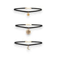 Mellow Monkey celestial layered choker set with black velvet bands and gold sun, moon, and star charms.