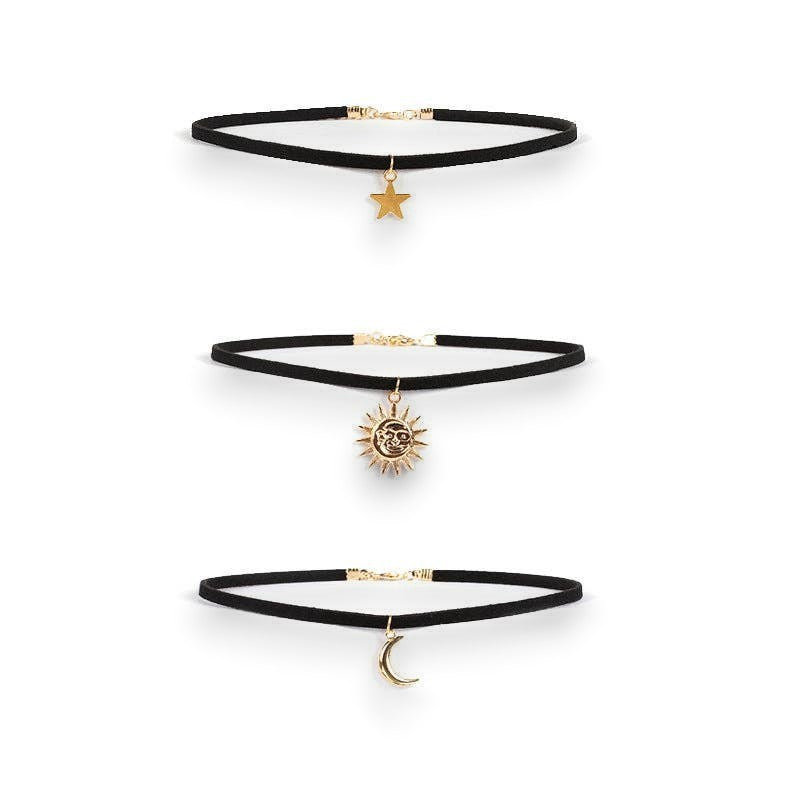Mellow Monkey celestial layered choker set with black velvet bands and gold sun, moon, and star charms.