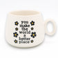Mellow Monkey ceramic cappuccino mug in white with black floral accents and You Make The World A Better Place text