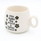 Mellow Monkey 11 oz ceramic cappuccino mug in cream with black floral accents and You Make The World A Better Place text