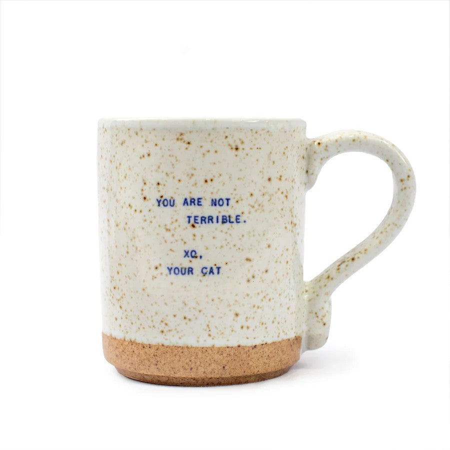 Mellow Monkey handmade ceramic mug with speckled cream glaze and blue text reading You are not terrible, Xo, your cat.