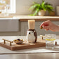 Mellow Monkey brown ceramic hedgehog toothpick holder on a wooden serving tray with bamboo toothpicks