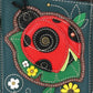 Mellow Monkey Chala turquoise faux leather crossbody wallet with ladybug applique and floral details.