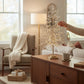 Mellow Monkey 23-inch champagne gold crystal tree with sparkling acrylic accents on a wooden living room side table.