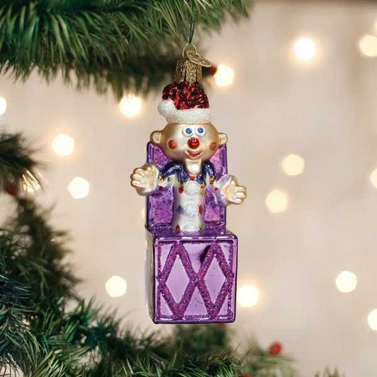 Mellow Monkey Charlie-In-The-Box blown glass Christmas ornament with Santa hat, purple box, and festive outfit.