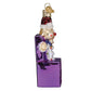 Mellow Monkey Charlie-In-The-Box blown glass Christmas ornament with red Santa hat and purple box.