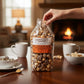 Mellow Monkey gourmet caramel popcorn with milk and white chocolate drizzle and California almonds in a clear bag.