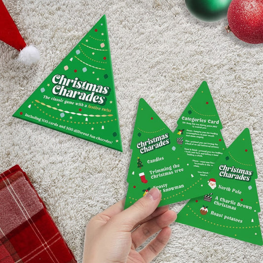 Mellow Monkey Christmas Charades game featuring tree-shaped cards with festive categories on a white rug background.