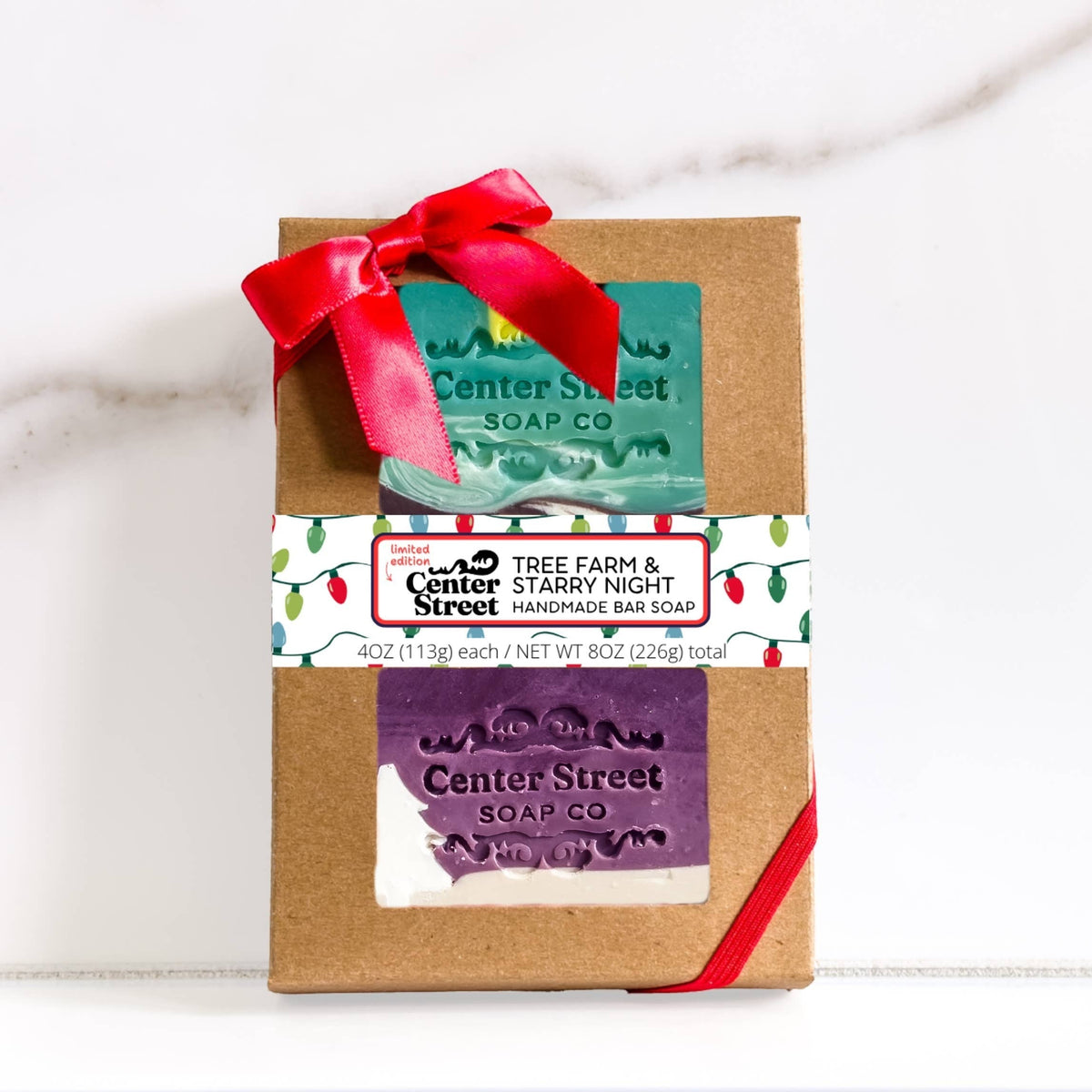 Mellow Monkey Tree Farm and Starry Night handmade vegan soap gift set in a kraft box with a festive red bow.