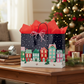 Mellow Monkey large Christmas gift bag with a festive village print, glossy finish, and red tissue paper.