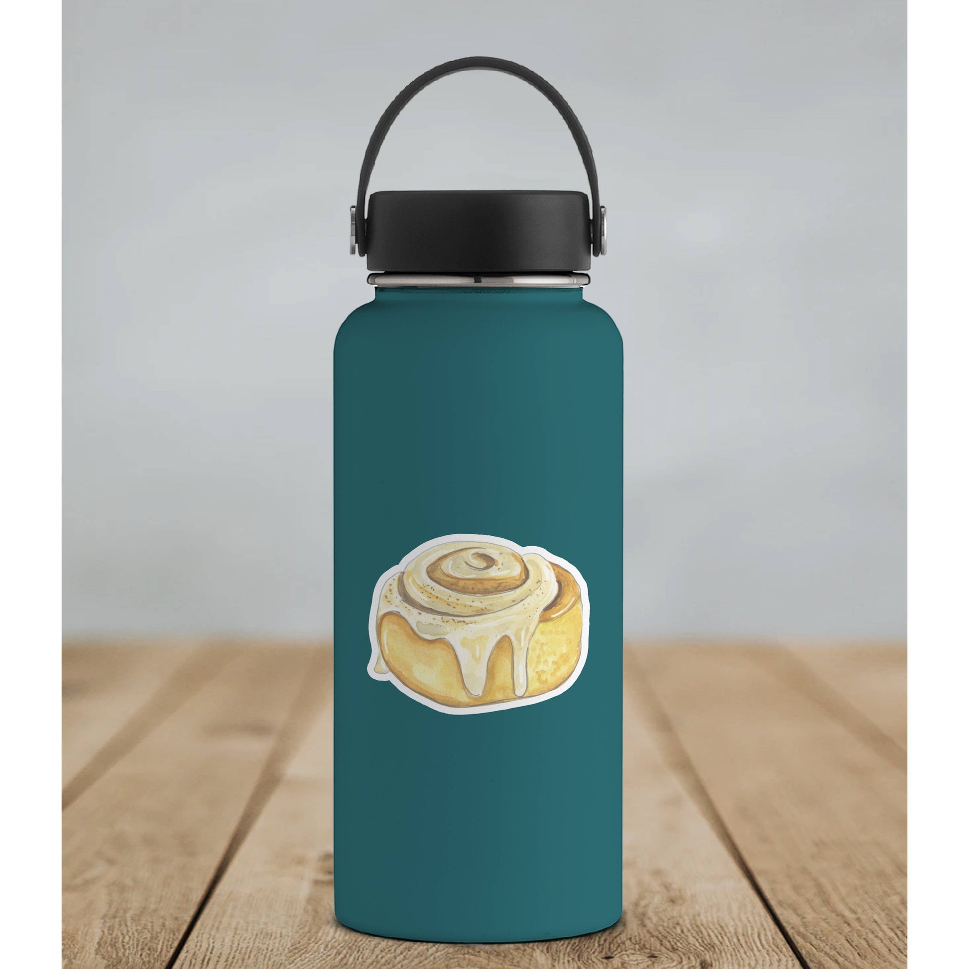 Mellow Monkey watercolor cinnamon roll vinyl sticker with dripping icing on a teal water bottle.