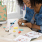 Mellow Monkey clay jewelry kit with colorful polymer clay, earring forms, and tools for crafting handmade accessories.