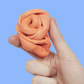 Mellow Monkey Speks Blur focus putty in clementine orange being stretched and squeezed by hand