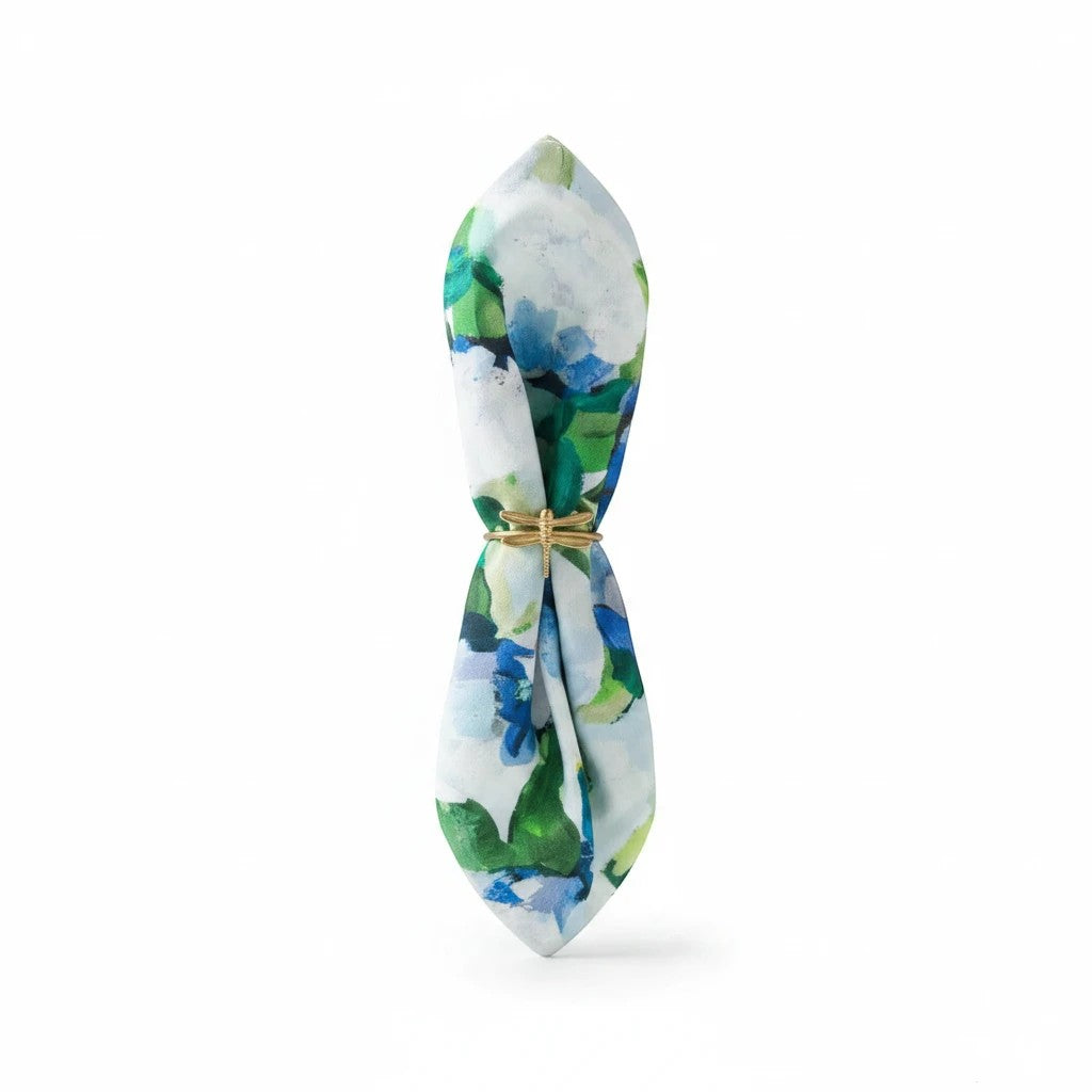 Mellow Monkey cotton dinner napkin featuring blue and green coastal hydrangea floral print with a gold napkin ring