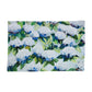 Mellow Monkey Coastal Hydrangea reversible woven cotton placemat with blue and white floral artwork on a wood table.