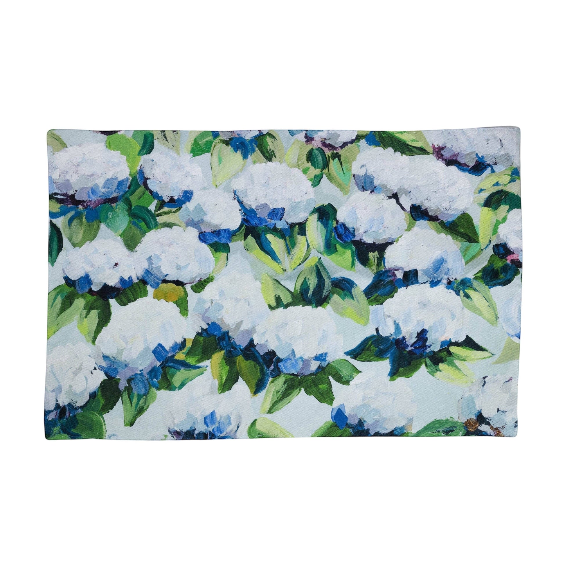 Mellow Monkey Coastal Hydrangea reversible woven cotton placemat with blue and white floral artwork on a wood table.