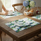 Mellow Monkey coastal hydrangea woven cotton placemats with blue and white floral print on a rustic wooden table