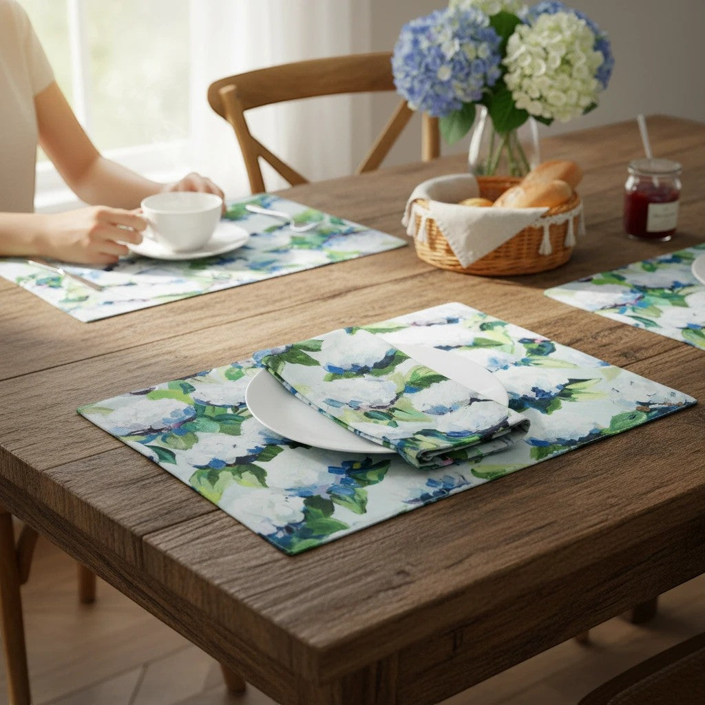 Mellow Monkey coastal hydrangea woven cotton placemats with blue and white floral print on a rustic wooden table
