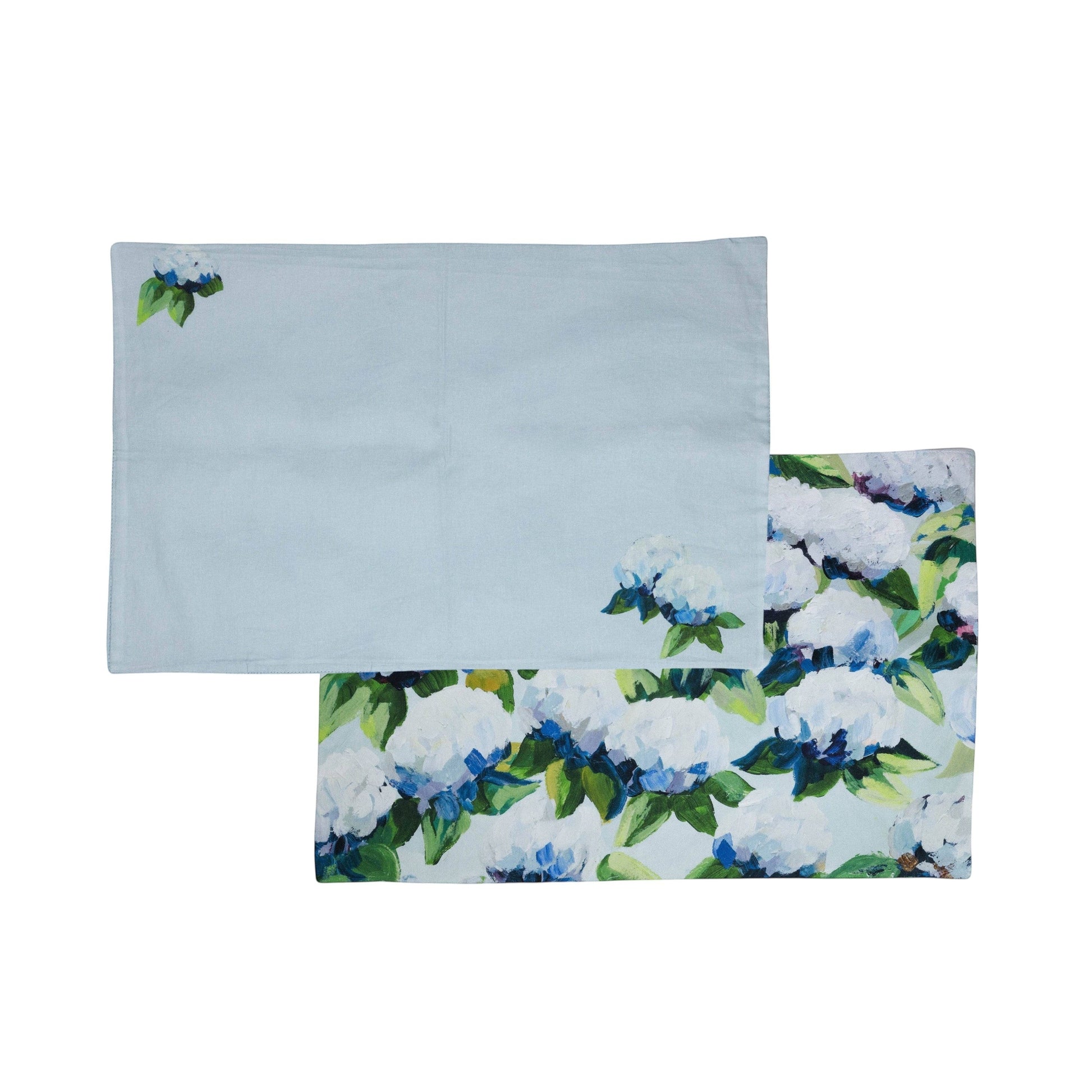 Mellow Monkey coastal hydrangea reversible woven cotton placemat in light blue with floral artwork on a wooden table