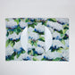 Mellow Monkey reversible woven cotton placemat featuring blue and white hydrangea artwork with a white dinner plate.
