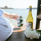 Mellow Monkey 16oz stainless steel wine tumbler with a blue and white coastal hydrangea floral print on a dock.