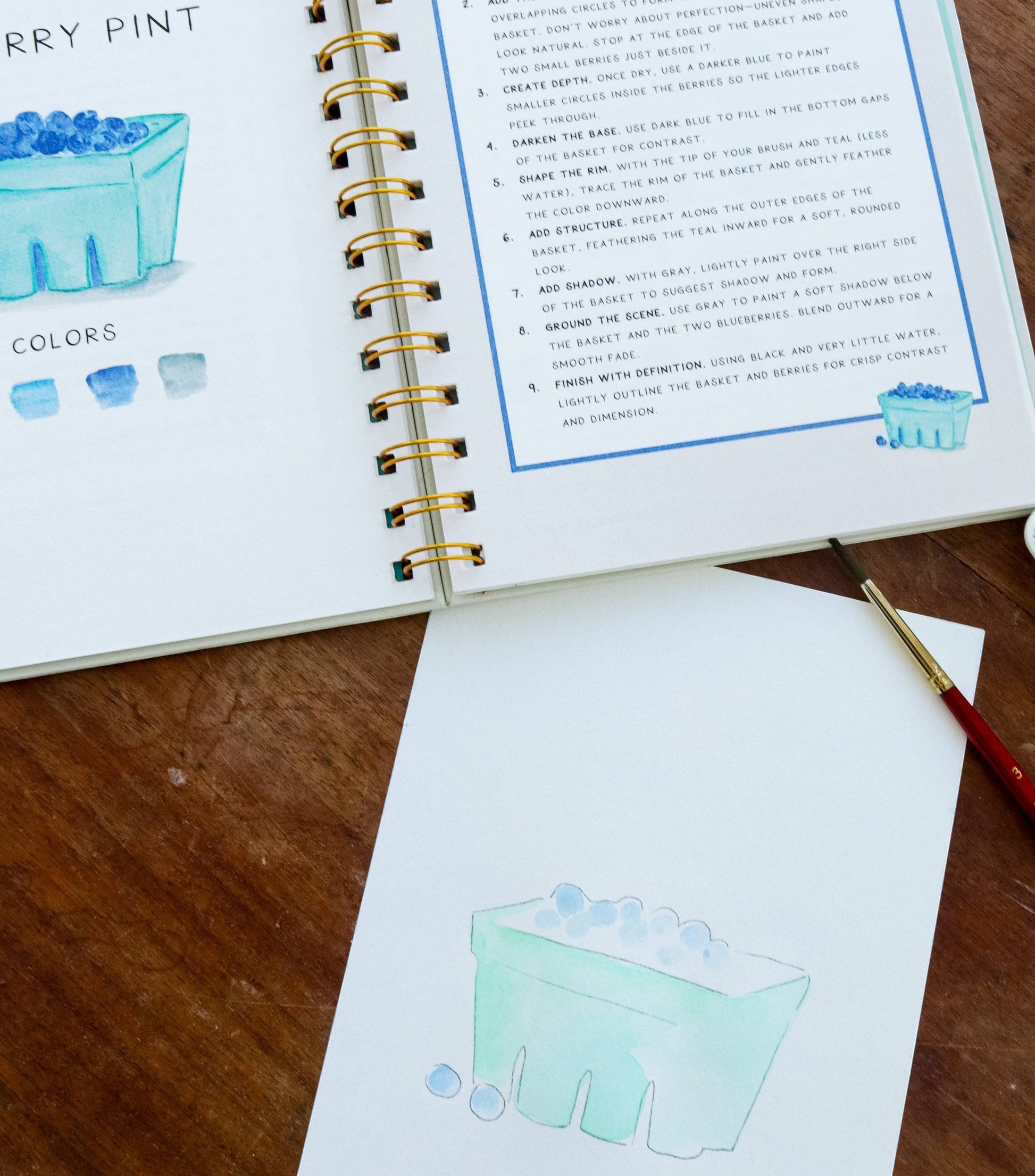 Mellow Monkey Coastin’ watercolor workbook with step-by-step painting instructions for a berry basket.