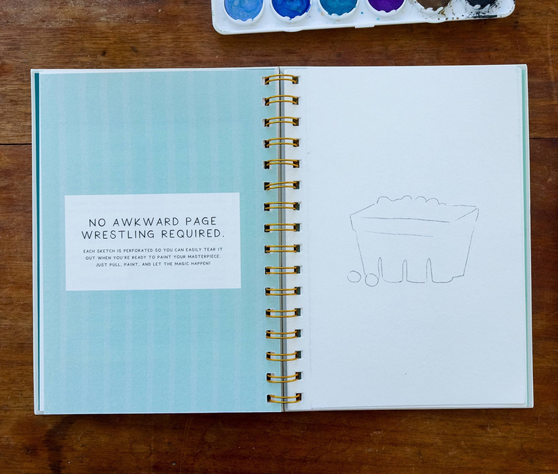 Mellow Monkey Coastin’ watercolor workbook open to a page with a sketch of a berry basket and text about tear-out pages.