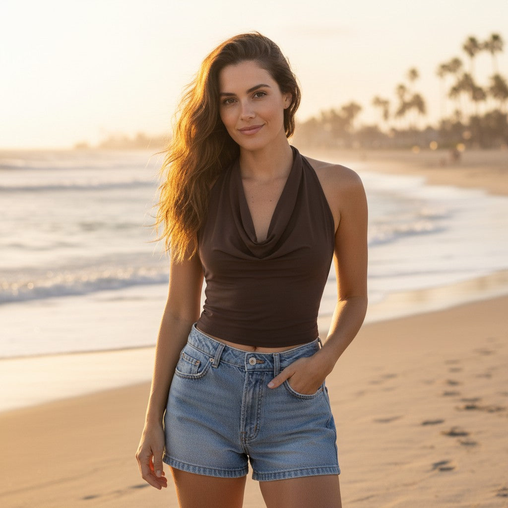 Mellow Monkey coffee brown halter neck tank top with a draped cowl neckline worn by a woman on a sunny beach.