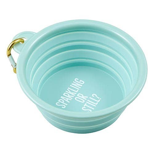 Mellow Monkey light blue collapsible silicone pet bowl with carabiner and "Sparkling or Still?" text.