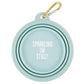 Mellow Monkey light blue collapsible silicone pet bowl with "Sparkling or Still?" text and gold carabiner.