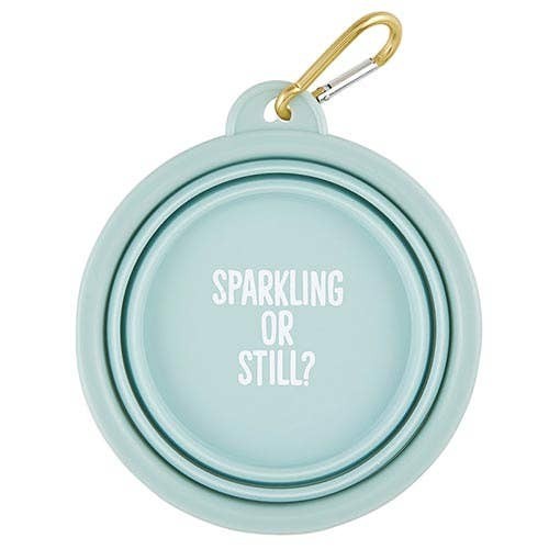 Mellow Monkey light blue collapsible silicone pet bowl with "Sparkling or Still?" text and gold carabiner.