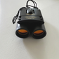 Mellow Monkey 30x60 compact folding roof prism binoculars with orange-tinted lenses for outdoor travel and hunting.