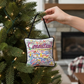 Mellow Monkey Connecticut mini pillow ornament with hand-embroidered state landmarks hanging on a Christmas tree.