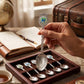 Mellow Monkey Connecticut jumbo souvenir spoon with a shield emblem and braided handle held over a display box