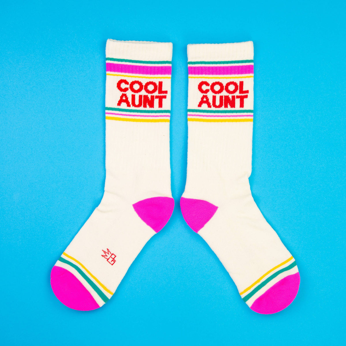 Mellow Monkey Cool Aunt gym crew socks in cream with pink heels, toes, and retro green and yellow striped cuffs.