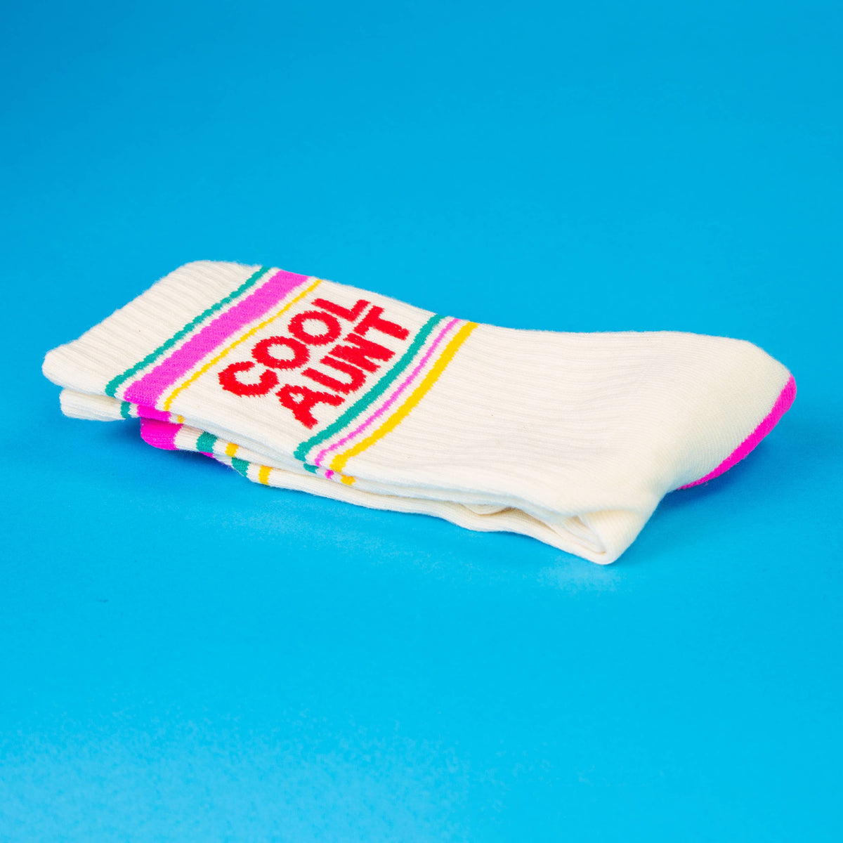 Mellow Monkey white gym crew socks with Cool Aunt text in red and pink and yellow stripes on a blue background