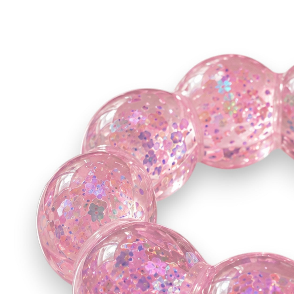 Mellow Monkey Cotton Candy Sparkle Feelzies sensory bracelet with pink glittery bubbles on a marble surface.